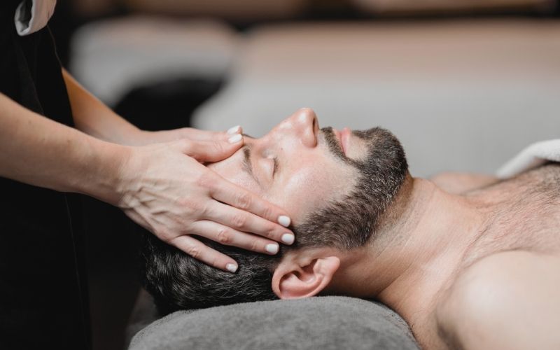Man receiving facial treatment at Hermanos Aesthetics Green Point Cape Town, offering facials, microneedling, skin boosters and chemical peels.